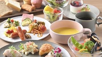 A variety of dishes including pasta, seafood, and bread, suggesting a diverse meal selection.