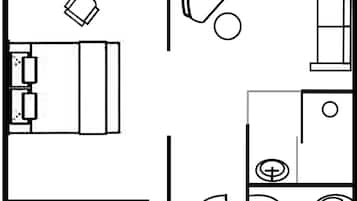 A floor plan with a bed, a desk, a chair, a small table, and a toilet.