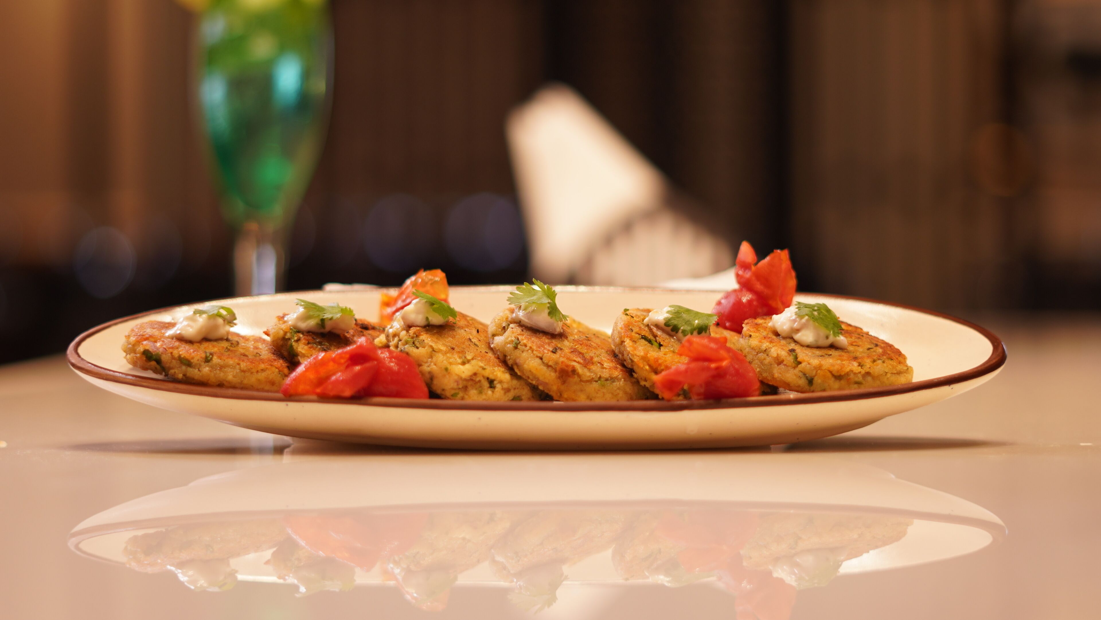 A plate of food with a creamy sauce, garnished with herbs and vegetables.