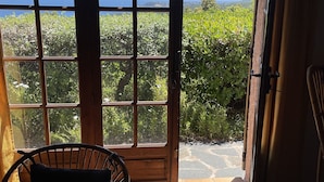 Ein Zimmer mit großem Fenster und Blick auf Meer und Grün.