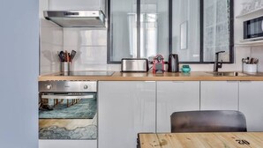 A modern kitchen with a built-in oven, a toaster, and a coffee maker on the countertop.