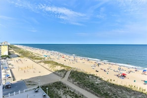 A beach with a volleyball court, a sandy area, and a view of the ocean. - New for 2022! Gateway Grand 609 offers Oceanfront Luxury (Ocean City)