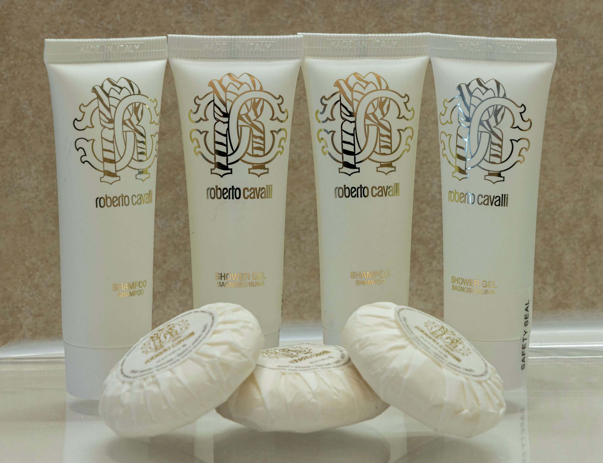 Four tubes of Roberto Cavalli shower gel and three bars of soap.