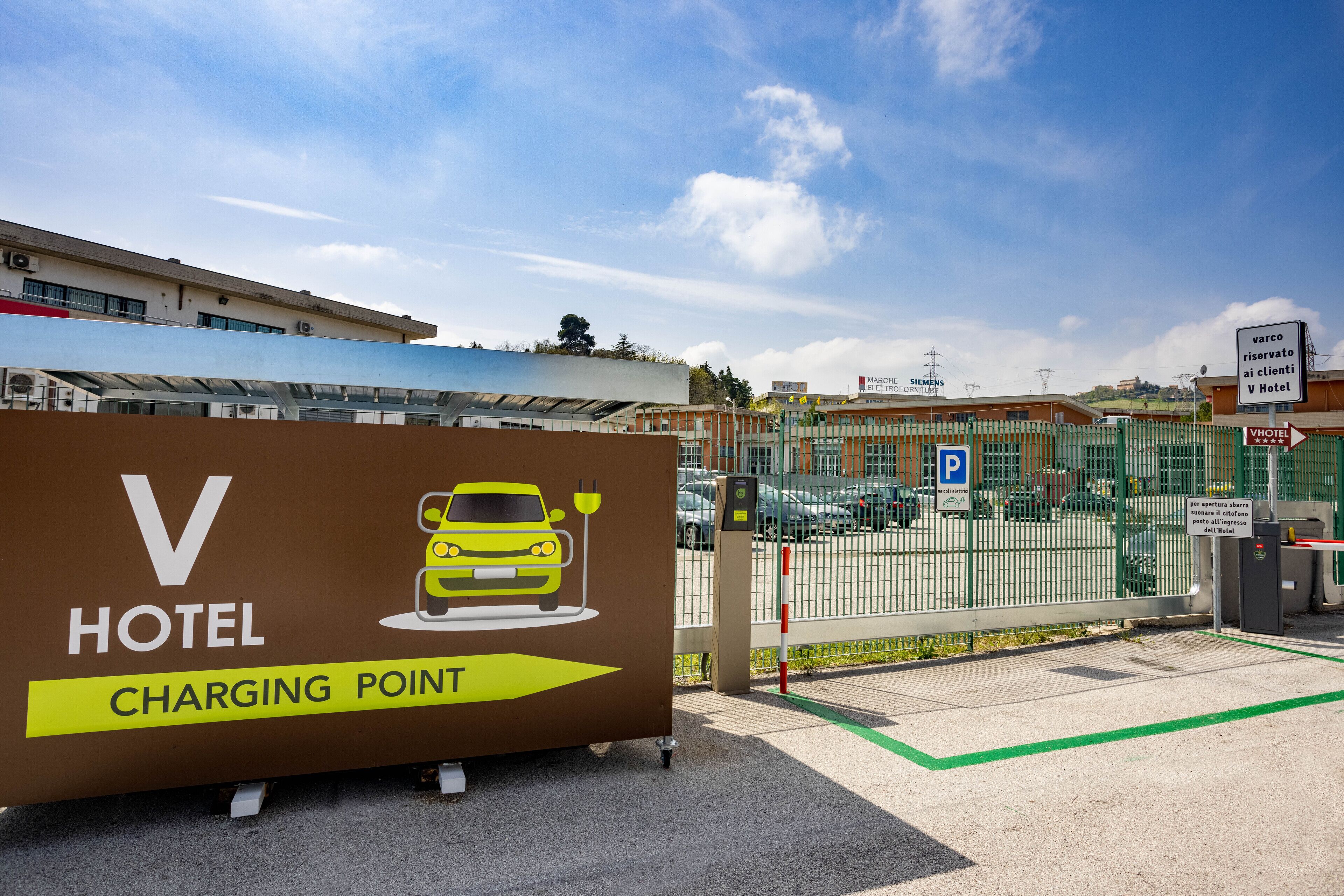 Un panneau d’hôtel indiquant un point de recharge pour véhicules électriques.
