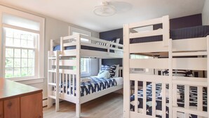 A room with bunk beds, a wooden desk, and a window with blinds. - Minutes to Nantucket Sound Beaches! (South Yarmouth)