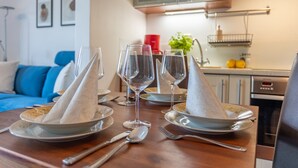 A dining table set with plates, glasses, and cutlery. - Vacation apartment by the sea, vacation on the island of Usedom, Apartment WIND ROSE 33 (Świnoujście)