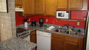 A kitchen with wooden cabinets, a microwave, a stove, and a dishwasher. - 4216  Hot tub, sauna & more resort amenities  Northview Retreat (Banner Elk)