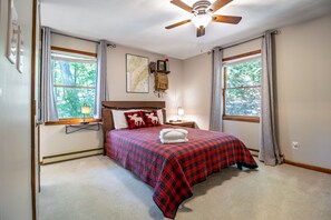 A bedroom with a bed, a nightstand, a lamp, a map on the wall, and a ceiling fan. - Hike the SNP-Massanutten Resort FREE Resort Rec Access & Dog Friendly! (McGaheysville)