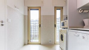 Cocina moderna con un microondas Bosch, lavadora y un lavaplatos.