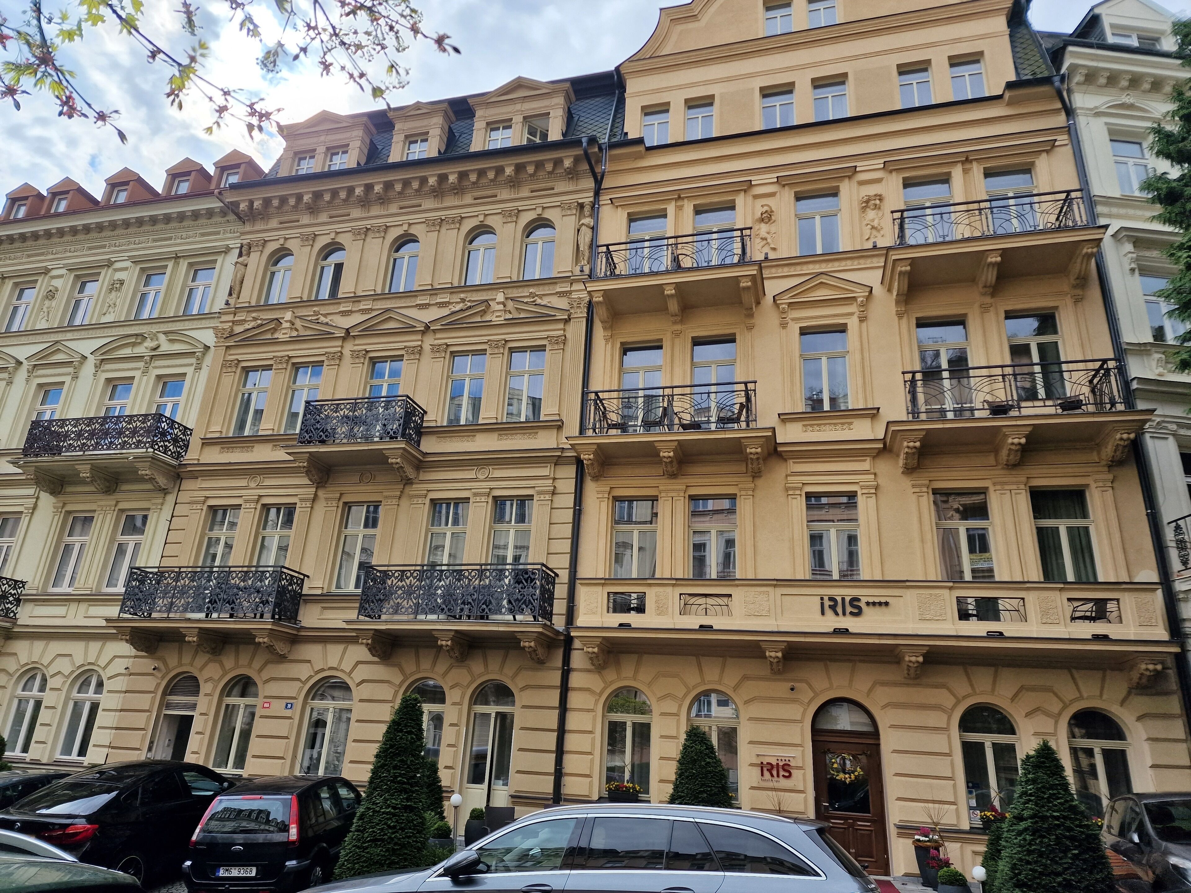 A multi-story building with ornate balconies and a sign reading "iris".