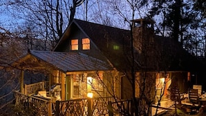 A cabin with a wooden deck, a covered porch, and a chimney. - Beautiful view with firepit and hot tub. Only 7 minutes to Cashiers and Glenville! (Cashiers)