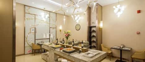 A modern interior with a central island counter, seating area, and decorative lighting.