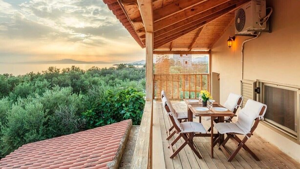A wooden deck with a table and chairs, overlooking a mountainous landscape. - Selinitsa Stone Residence-Private Poolside Retreat (Agios Nikolaos)
