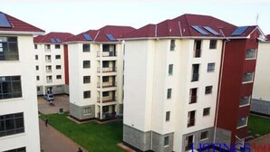 A multi-story residential building with balconies and solar panels. - Stay.Plus Kahawa Sukari Apartment (Ruiru)