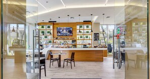 Enjoy a drink at the central bar, surrounded by a selection of beverages and comfortable seating.