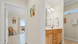 A bathroom with a wooden vanity, a large mirror, and a window. - Off The Hook - Very Private Lot With Amazing Gulf Views Perfect For Your Family Beach Vacation 4 Bedroom Home by RedAwning (Dauphin Island)