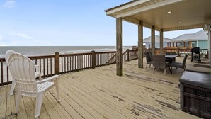 A wooden deck with a covered seating area overlooking the ocean. - Off The Hook - Very Private Lot With Amazing Gulf Views Perfect For Your Family Beach Vacation 4 Bedroom Home by RedAwning (Dauphin Island)
