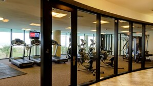 A gym with treadmills, exercise bikes, and weight machines. - Calm Seas - Holiday Isle #119 - Tremendous Views, A Beautiful Gulf Front Pool, A Heated Indoor Pool, Jacuzzi, Steam Room, And Gulf View Fitness Center. 2 Bedroom Condo by RedAwning (Dauphin Island)