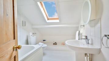Bathtub, towels, soap, toilet paper