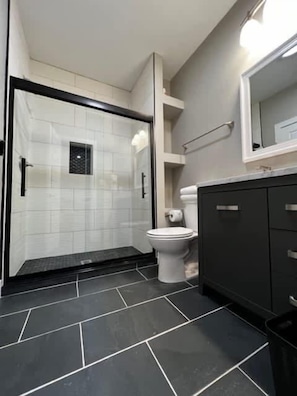 Bathtub, hair dryer, towels, shampoo