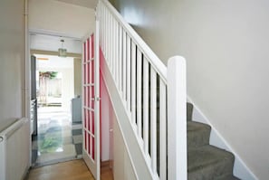 Staircase leads to an outdoor area through a partially open door.