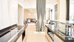 A modern hotel lobby with marble walls, a central column, and a long reception counter. - KATAMARE (Becici)