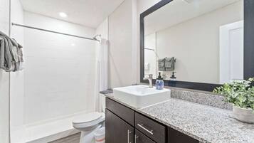 Shower, hair dryer, towels, shampoo