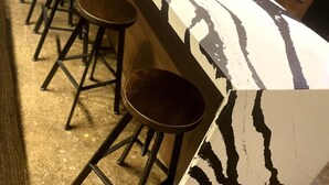 A bar area with a long counter and multiple stools. - 424 Gold Way-Apt 402, 2 Bed/1Bath (Pittsburgh)