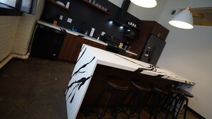 A modern kitchen with a central island, bar stools, and pendant lighting. - 424 Gold Way - Apt. 404 2Bed/1Bath  (Pittsburgh)