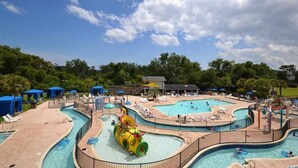 A water park with multiple pools, slides, and lounge areas. - BEACH BLISS 2Bedroom/2 Bath condo in Litchfield! (Pawleys Island)