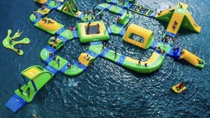 Vue aérienne d’un parc aquatique avec différentes structures de jeux gonflables et toboggans.