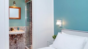 A bathroom with a shower, sink, and mirror.