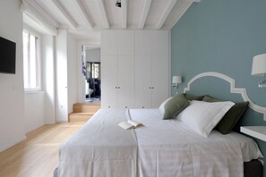 A bedroom with a bed, a book, and a nightstand.