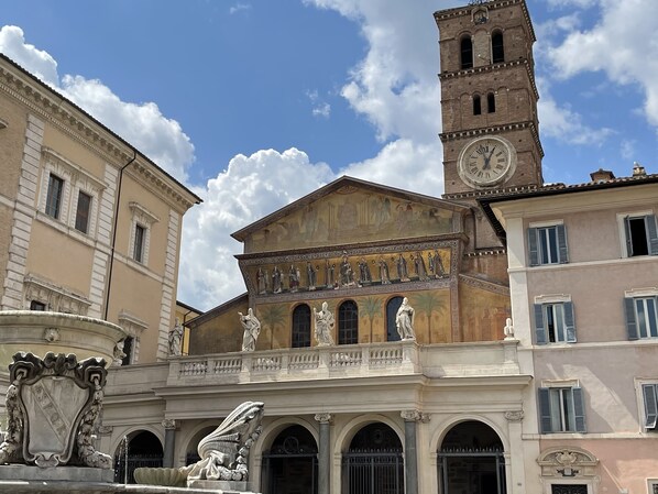 A historic building with classical architecture, including a prominent clock tower and detailed sculptures.