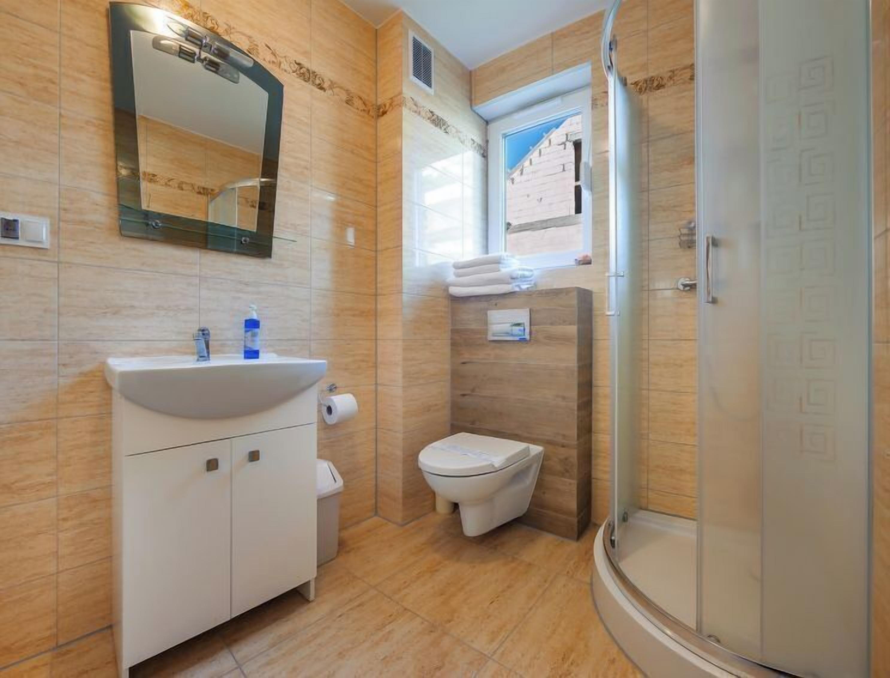 A bathroom with a sink, toilet, and shower.