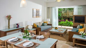 A modern living room with a dining area, a sofa set, and a television. - 5 star resort week of mexico open held at same resort (Nayarit CP)