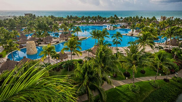 A resort with multiple swimming pools surrounded by palm trees and a view of the ocean. - 5 star resort week of mexico open held at same resort (Nayarit CP)