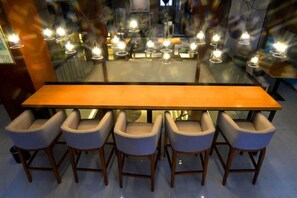 A modern dining area with a long wooden table and six chairs. - Ceeci Hotel (Xichuan)