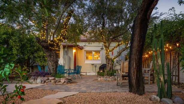 A house with a patio, outdoor seating, and string lights.