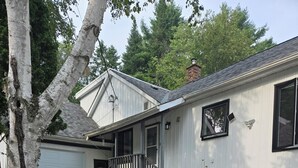 A single-story house with a front porch, a garage, and a brick section on the right.