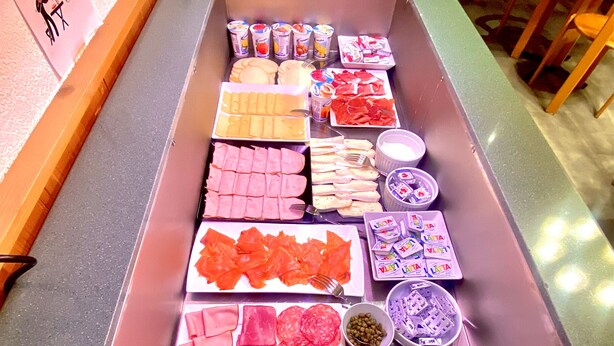 A buffet with various food items including meats, cheeses, and condiments. - Hotel Sternen (Aarau)