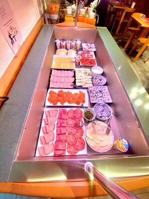 A buffet with various food items including meats, cheeses, and condiments. - Hotel Sternen (Aarau)