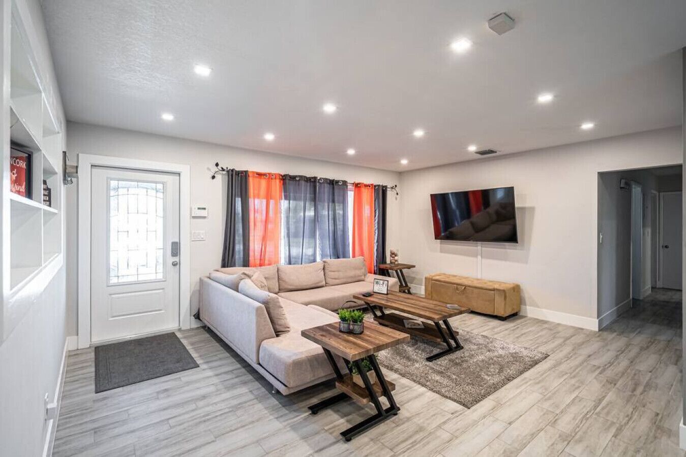 A modern living room with a sofa, coffee table, and TV.