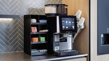 A coffee machine with a digital display, a coffee grinder, and a coffee bean container.