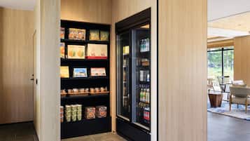 Una cocina moderna con armarios de madera, un refrigerador empotrado y una variedad de alimentos en estantes.