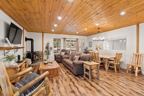 Una sala de estar acogedora con chimenea, muebles de madera y televisor.