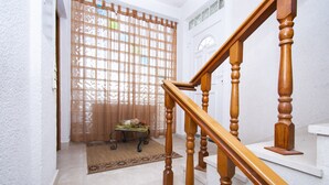 A staircase with wooden balusters leading to a landing.