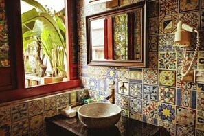A bathroom with a large window, a mirror, and a bowl sink. - Fanhua Courtyard (Chongqing)
