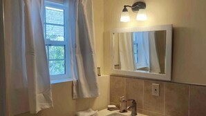 A bathroom with a sink, mirror, towel rack, and a window with curtains. - A totally separated beautiful golf⛳️course view small  house in the back yard  (Daly City)