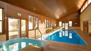 An indoor swimming pool with a wooden ceiling and stone flooring. - Fort Marcy 35 | Just Like Home - But Even Better! 2-Bdrm, Walk To Plaza, Fireplace (Santa Fe)